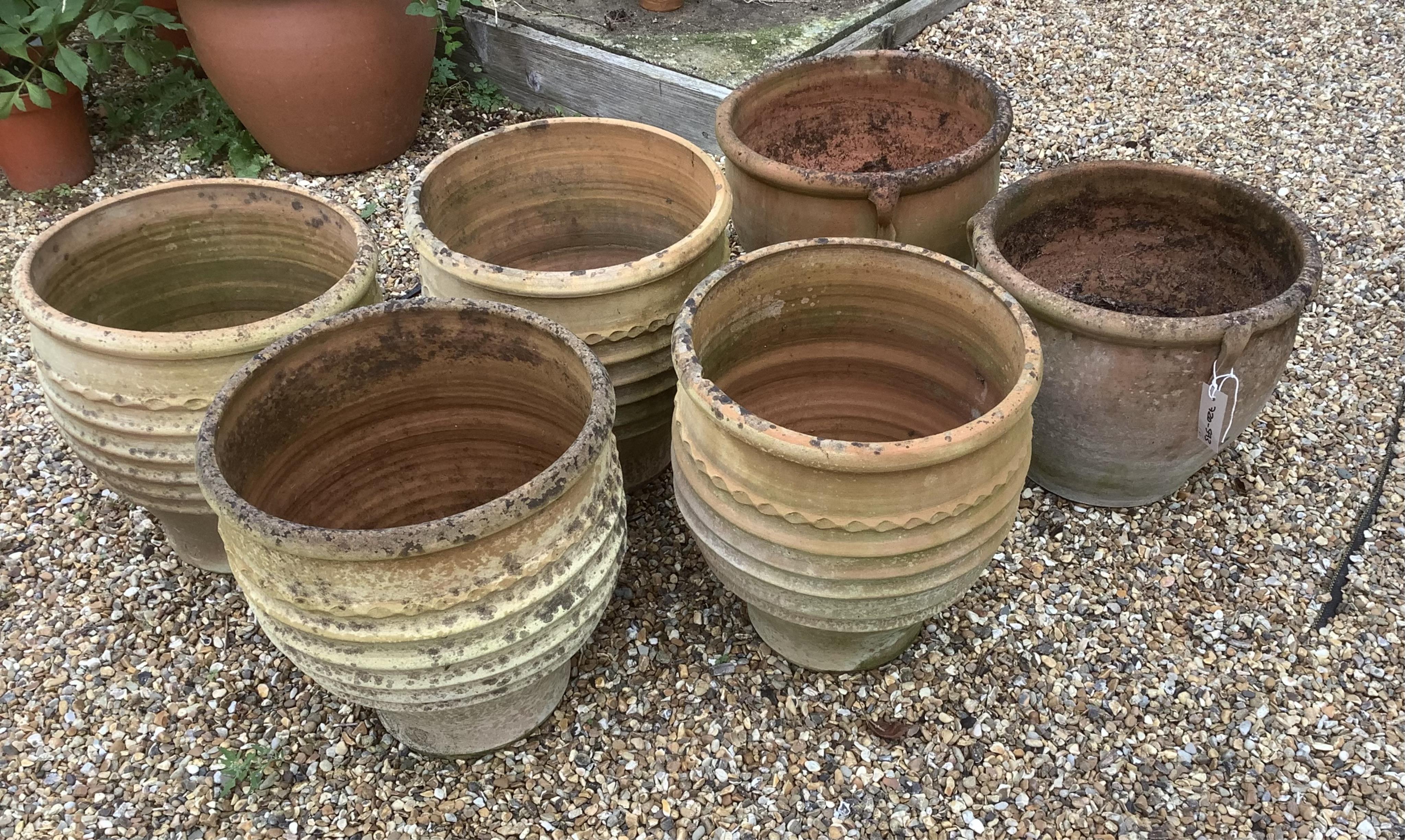 A set of four Minos Italian style terracotta planters, height 35cm, depth 40cm, and a pair of similar planters, planting removed. Condition - weathered, otherwise good